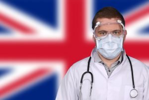 doctor in PPE in front of union flag