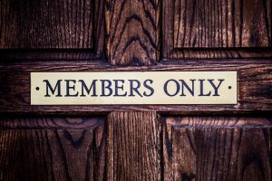 wooden door, brass paque 'Members only'