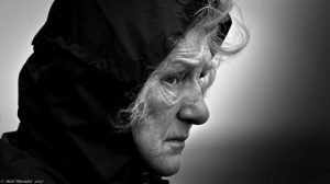 profile of older woman, cold and alone