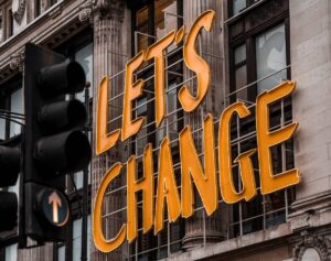 neon sign reads 'Let's change'