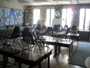 empty classroom, chairs stacked on desks